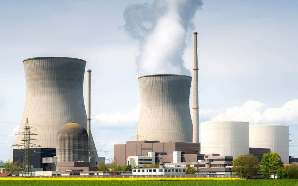 A large industrial facility with multiple cooling towers emitting steam, labeled "Cooling Systems